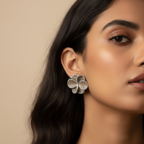 Champagne-colored floral stud earrings with shimmering crystals.